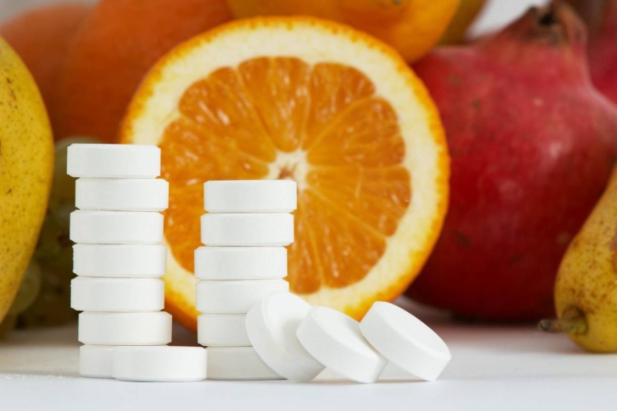 High Dose Vitamin C Tablets with fresh fruits, symbolizing energy, glowing skin, and strong immunity