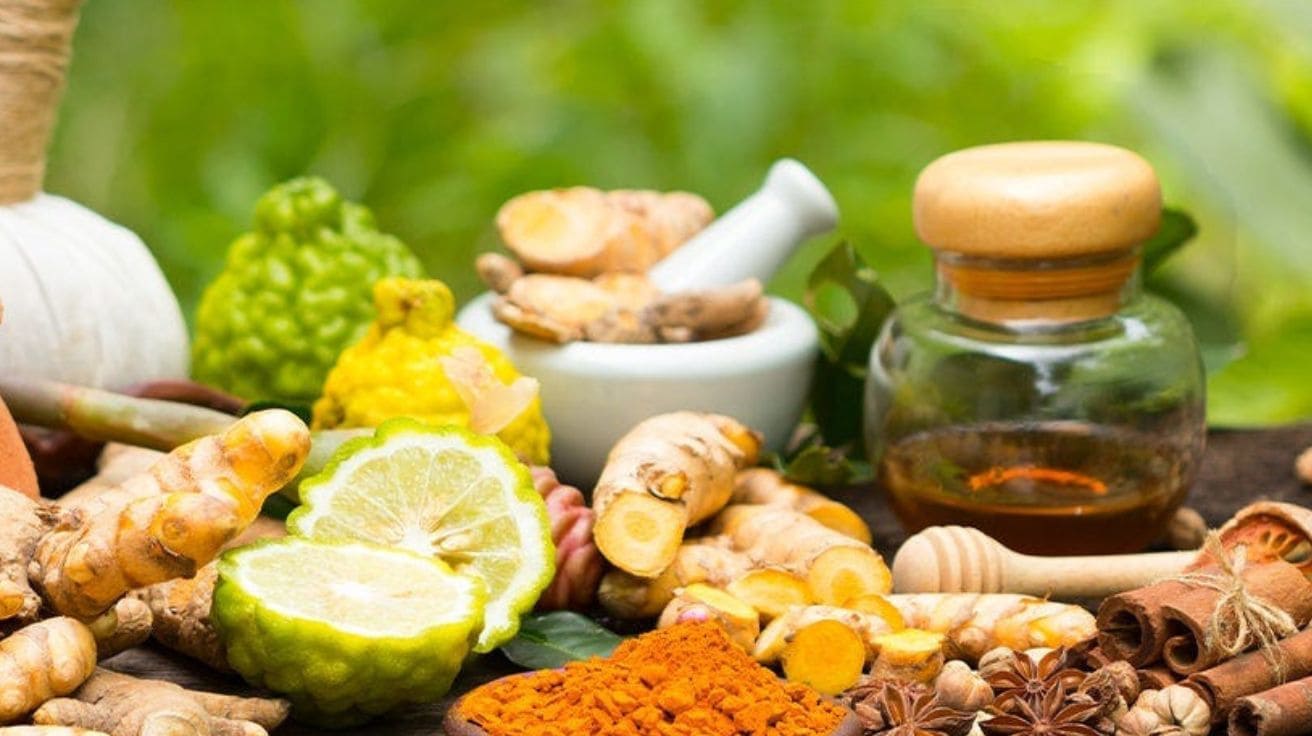  A warm cup of herbal tea made with fresh mint leaves, sliced ginger, and lemon, placed on a wooden table — showcasing a natural home remedy  .